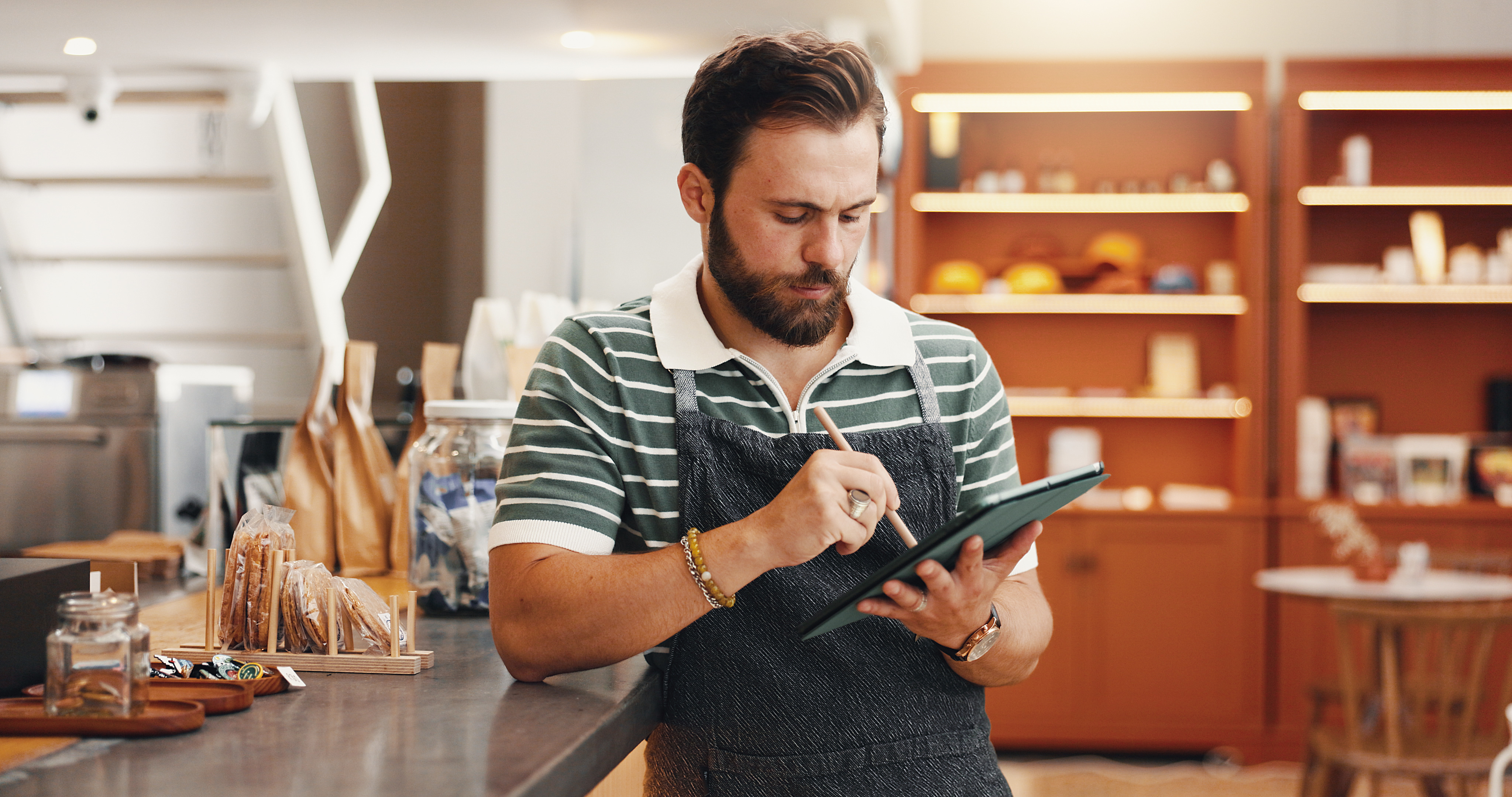 /media/2gbbu0bq/bearded-man-using-a-tablet-in-coffee-shop-2026-09-24-12-48-03-utc.jpg