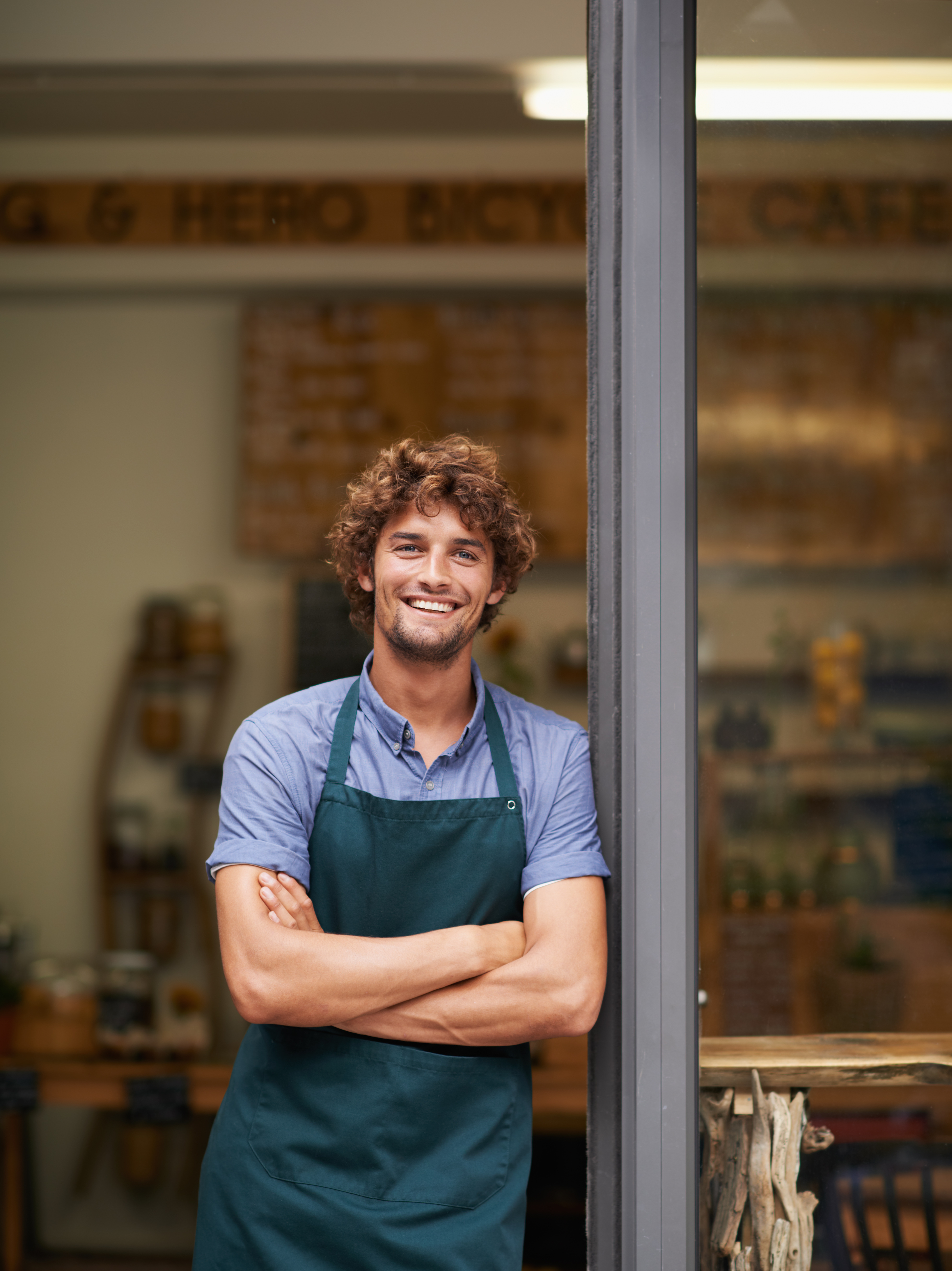 /media/3e5h23ti/smiling-cafe-owner-leaning-in-doorway-2026-03-25-03-17-15-utc.jpg