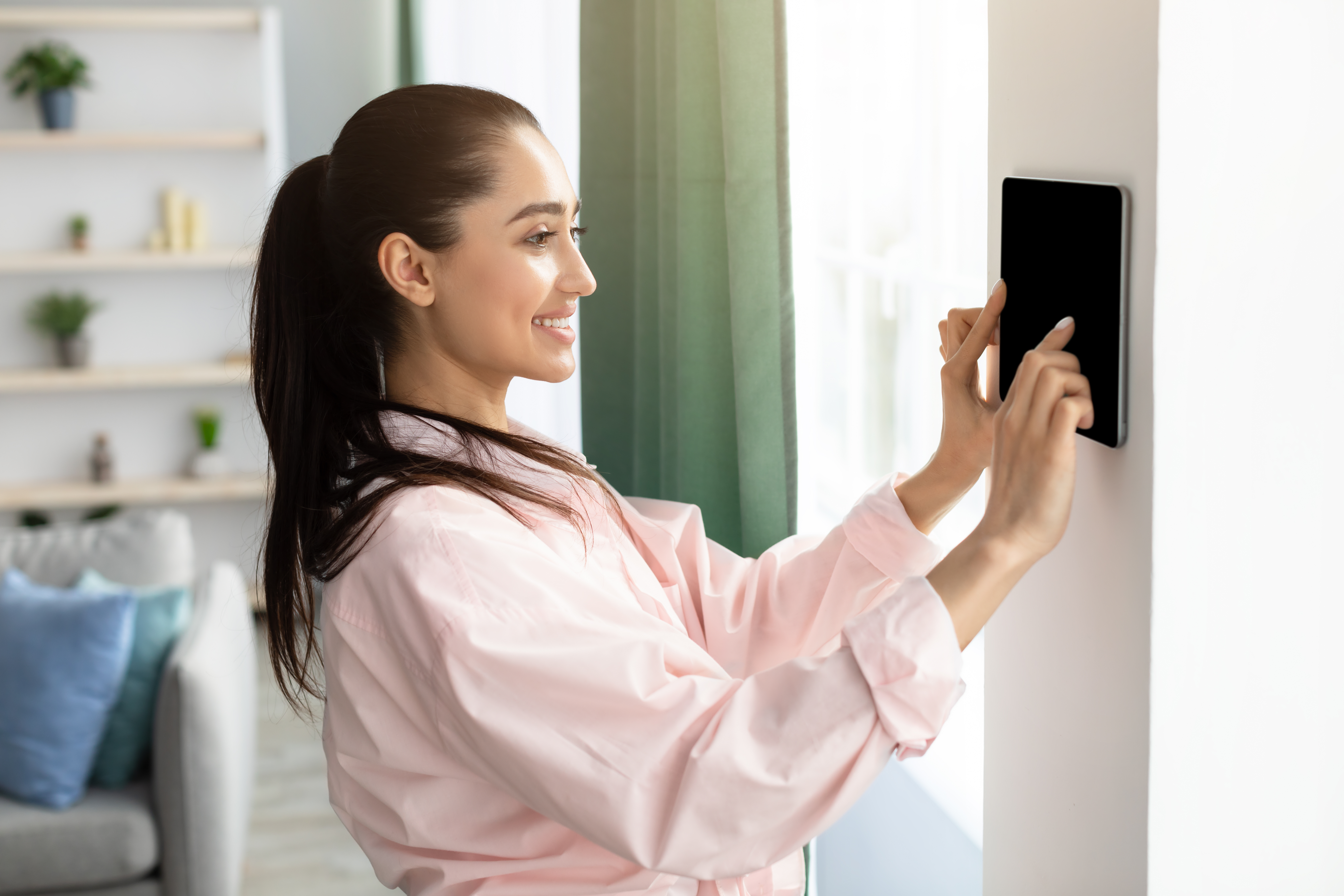 /media/nuiaijij/woman-interacting-with-smart-home-control-panel-2026-03-25-01-44-25-utc.jpg